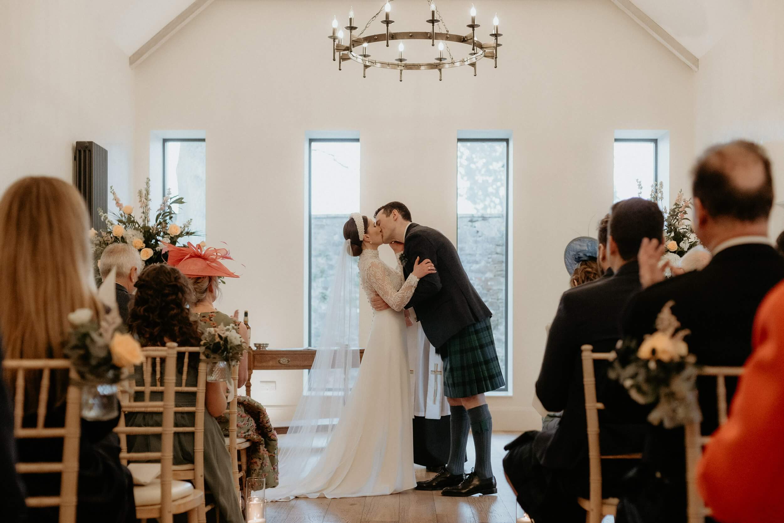 A wedding photographer in Scotland takes candid shots of a couple celebrating their wedding amidst stunning natural scenery.